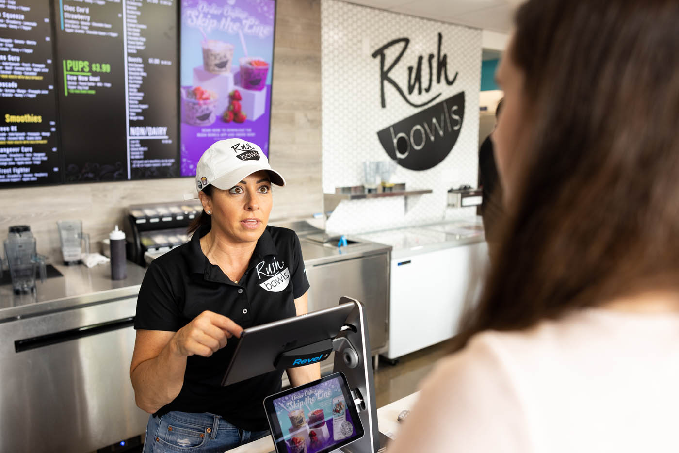 These three young women sip on Rush Bowls smoothies and are consistent customers in the health food industry.